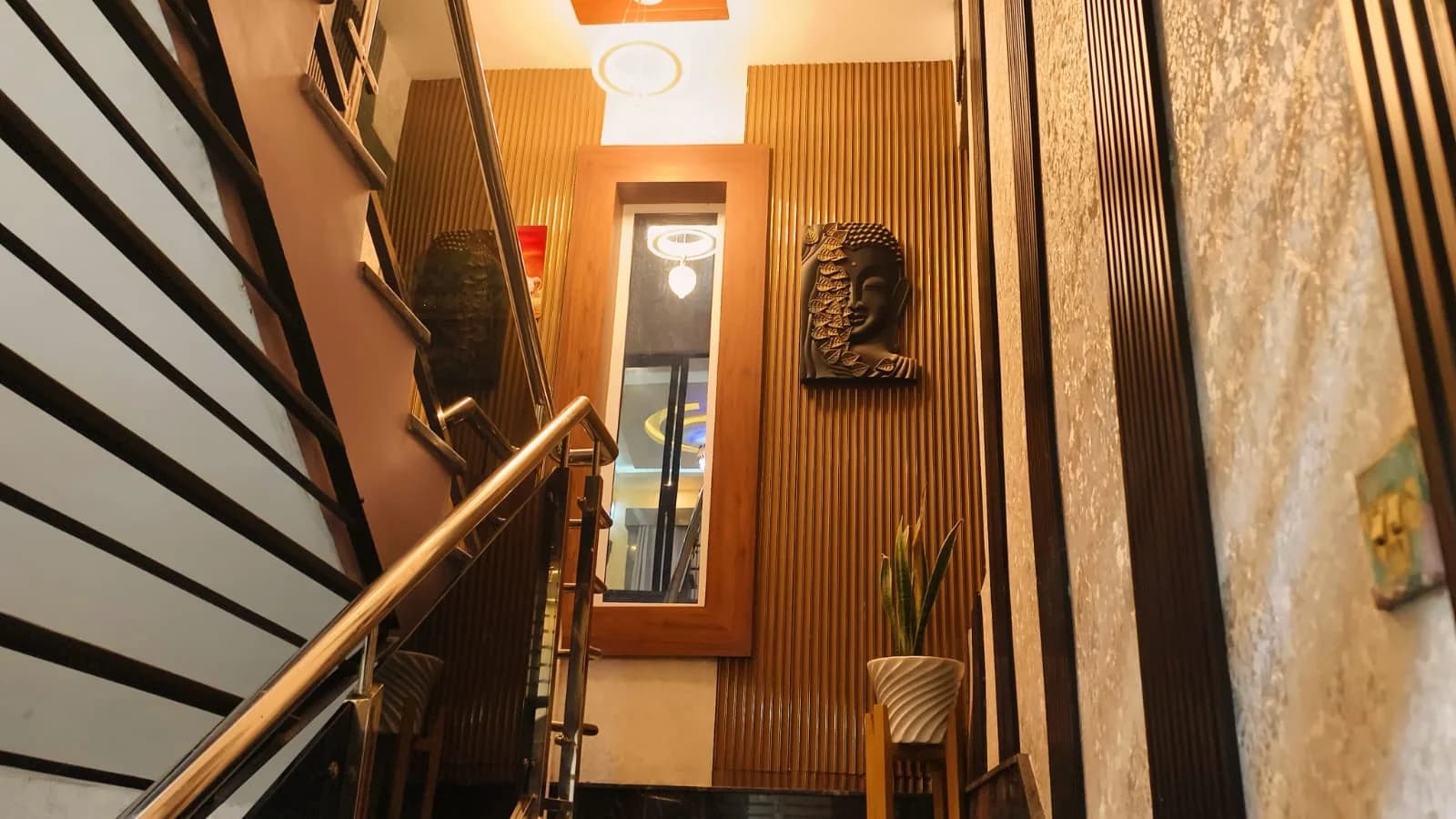 Stairway with Buddha relief artwork and mirror